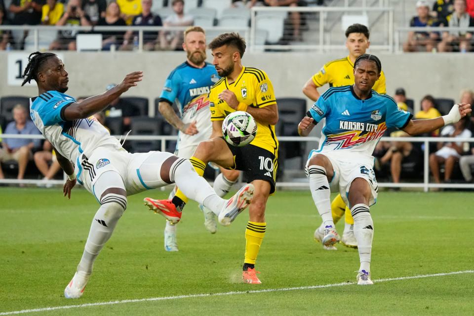 Aug 9, 2024; Columbus, OH, USA; Sporting Kansas City defender Dany Rosero (5) clears the ball in front of Columbus Crew forward Diego Rossi (10) during the first half of the Leagues Cup soccer match at Lower.com Field.