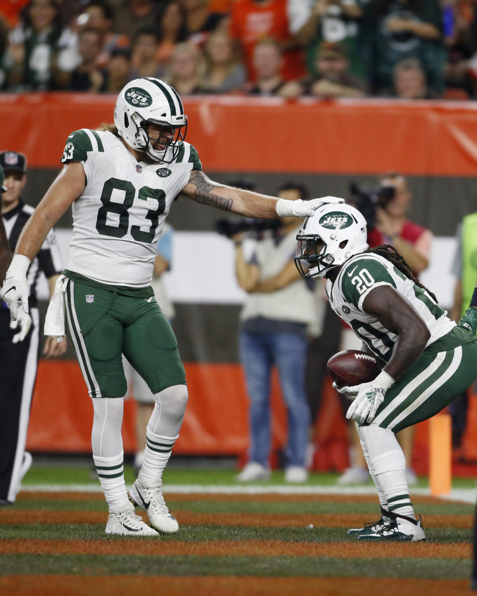 New York Jets tight end Eric Tomlinson (83) congratulates running back Isaiah Crowell (20) after Crowell ran for a two-yard touchdown during the first half of an NFL football game against the Cleveland Browns, Thursday, Sept. 20, 2018, in Cleveland. (AP Photo/Ron Schwane)