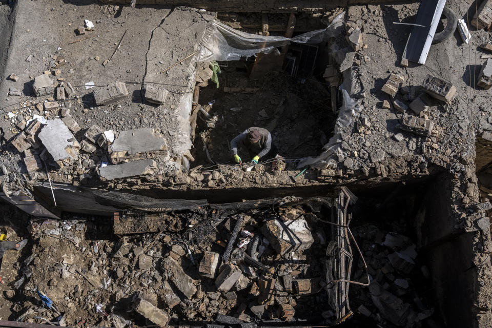 An Afghan man inspects the site of the explosion in a sports club, in the west of Kabul, Afghanistan, Friday, Oct. 27, 2023. The blast killed some people and injured others in a Shiite neighbourhood in the Afghan capital Kabul. (AP Photo/Ebrahim Noroozi)