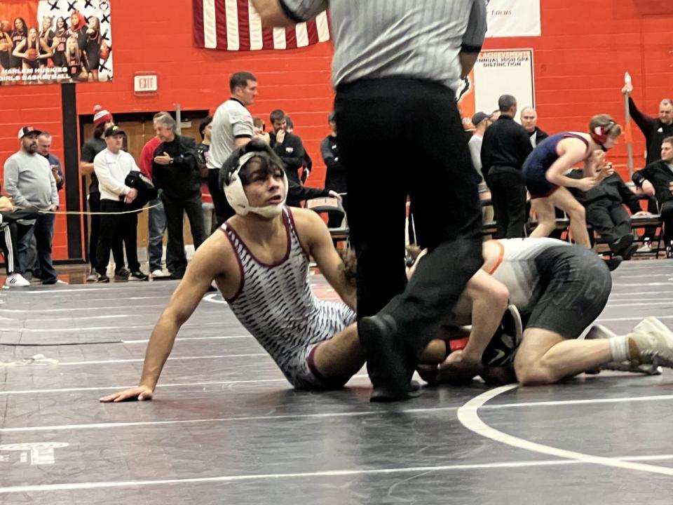 Dakota's TJ Silva looks up to the referee during his 126-pound championship match at the Dvorak Wrestling Tournament on Sunday, Dec. 18, 2022, in Machesney Park.