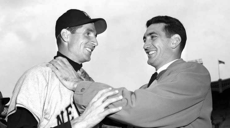 FILE - In this Oct. 10, 1951, file photo, Bobby Thomson, left, of the New York Giants, and Ralph Branca of the Brooklyn Dodgers engage in horse play before a World Series baseball game at Yankee Stadium in New York. On Oct. 3, 1951, Thomson had hit a home run, 