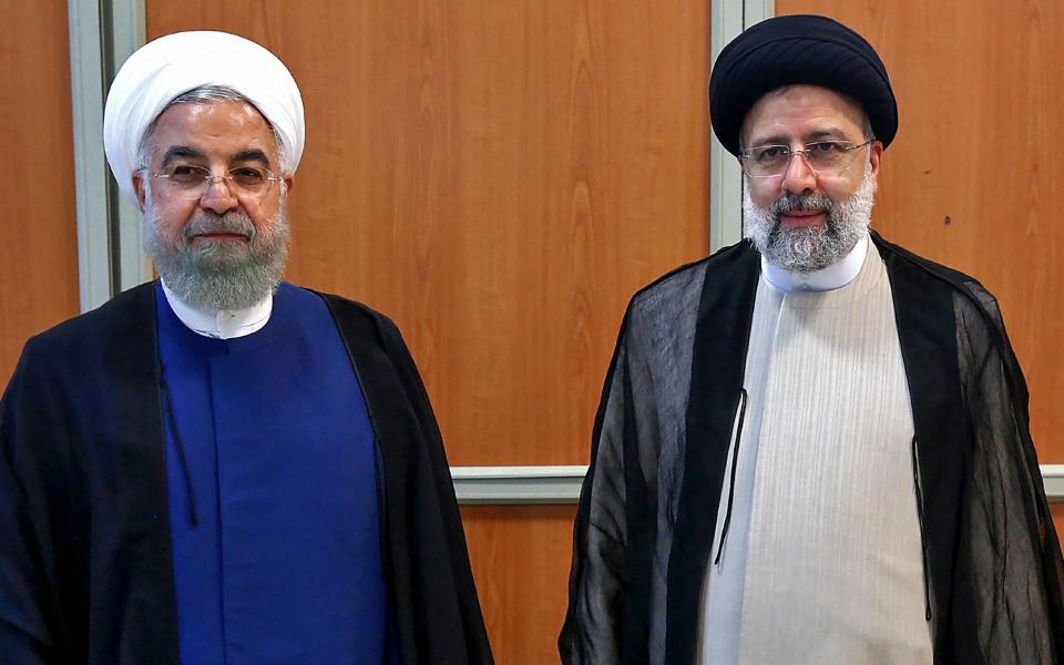 Iran's former president Hassan Rouhani with his successor Ebrahim Raisi - KHAMENEI.IR / AFP