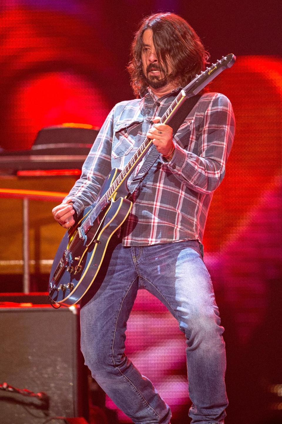FILE - This May 18, 2013 file photo shows Dave Grohl performing as a special guest with the Rolling Stones at Honda Center in Anaheim, Calif. When Zac Brown bumped into Dave Grohl while picking up some altered clothes for the Grammy Awards, he didn't let the random meeting go to waste. They bonded over their love of analog recording gear and their new friendship eventually resulted in Zac Brown Band's newest release: "The Grohl Sessions Vol. 1." (Photo by Paul A. Hebert/Invision/AP, File)