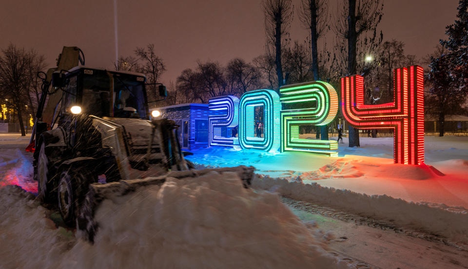 A tractor cleans snow next to decorations marking the New Year 2024 at the Exhibition of Achievements of National Economy (VDNH) during a heavy snowfall in Moscow, Russia December 3, 2023. REUTERS/Maxim Shemetov