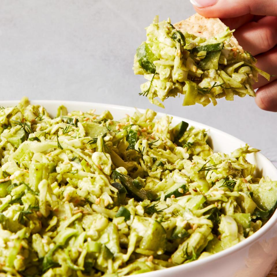 finely chopped green vegetables in a bowl with tortilla chips