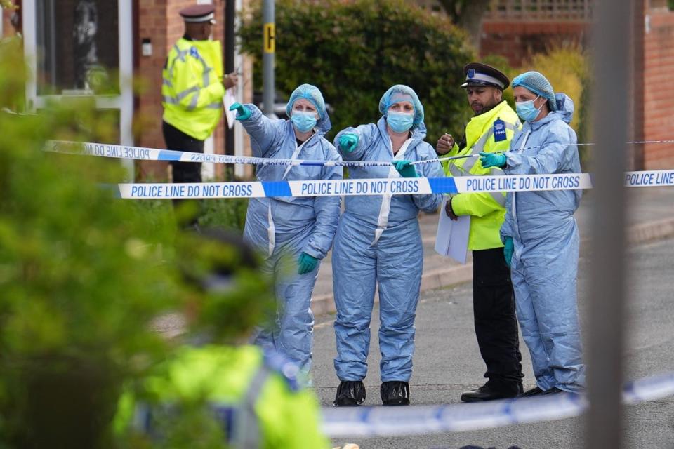 Forensic investigators in Laing Close in Hainault (PA Wire)