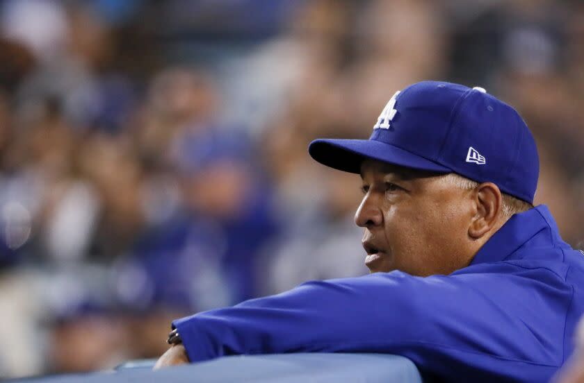 Dodgers manager Dave Roberts watches from the dugout
