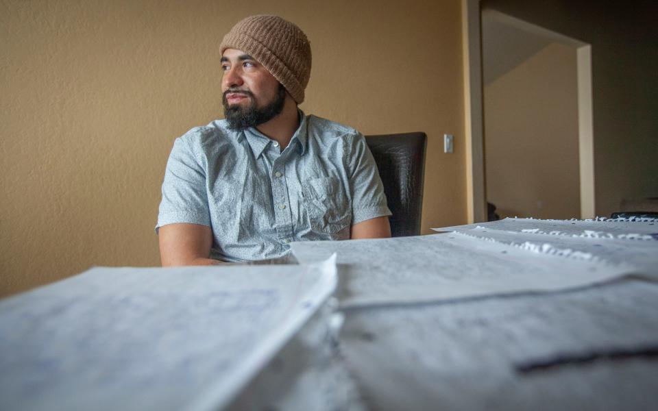 Fernando Aguirre looks through notes he made about his time in detention at his home in Kennewick, Washington, Dec. 8, 2019. Aguirre pleaded guilty to drug possession and spent eight months (of a one year sentence) in jail. Once he completed his sentence, ICE took custody of him and he then spent seven years at the detention center in Tacoma awaiting his deportation.