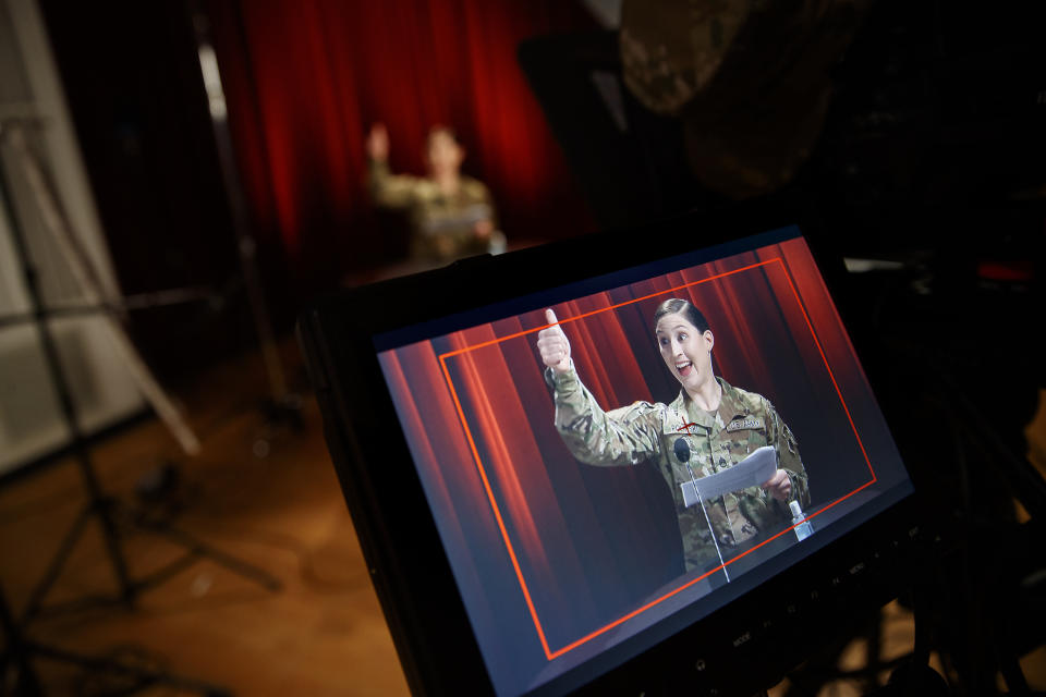 U.S. Army Field Band member Staff Sgt. Sarah Polinski, originally of Sayre, Pa., is seen on a monitor as she gives the thumbs up during the rehearsal of their daily "We Stand Ready" virtual concert series at Fort George G. Meade in Fort Meade, Md., Wednesday, March 25, 2020. The Army Field Band's mission is to bring the military's story to the American people. And they're not letting the coronavirus get in the way. (AP Photo/Carolyn Kaster)