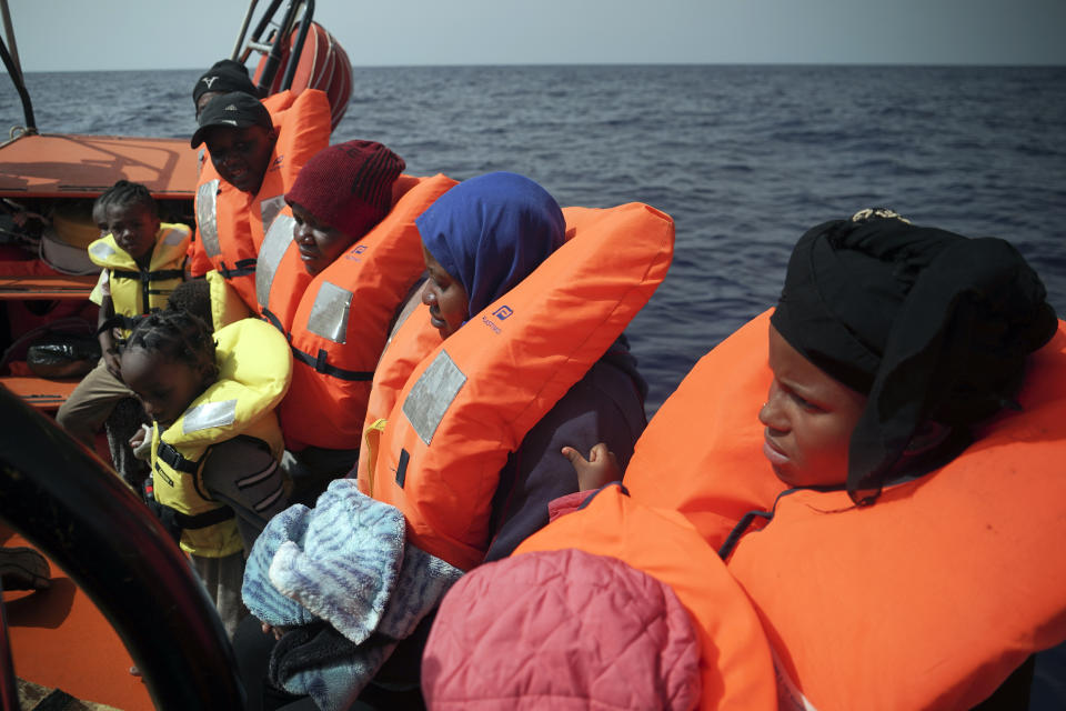 Women and children sit on a rescue boat some 53 nautical miles (98 kilometers) from the coast of Libya in the Mediterranean Sea, Tuesday, Sept. 17, 2019. The humanitarian rescue ship Ocean Viking pulled 48 people from a small and overcrowded wooden boat including a newborn and a pregnant woman.(AP Photo/Renata Brito)