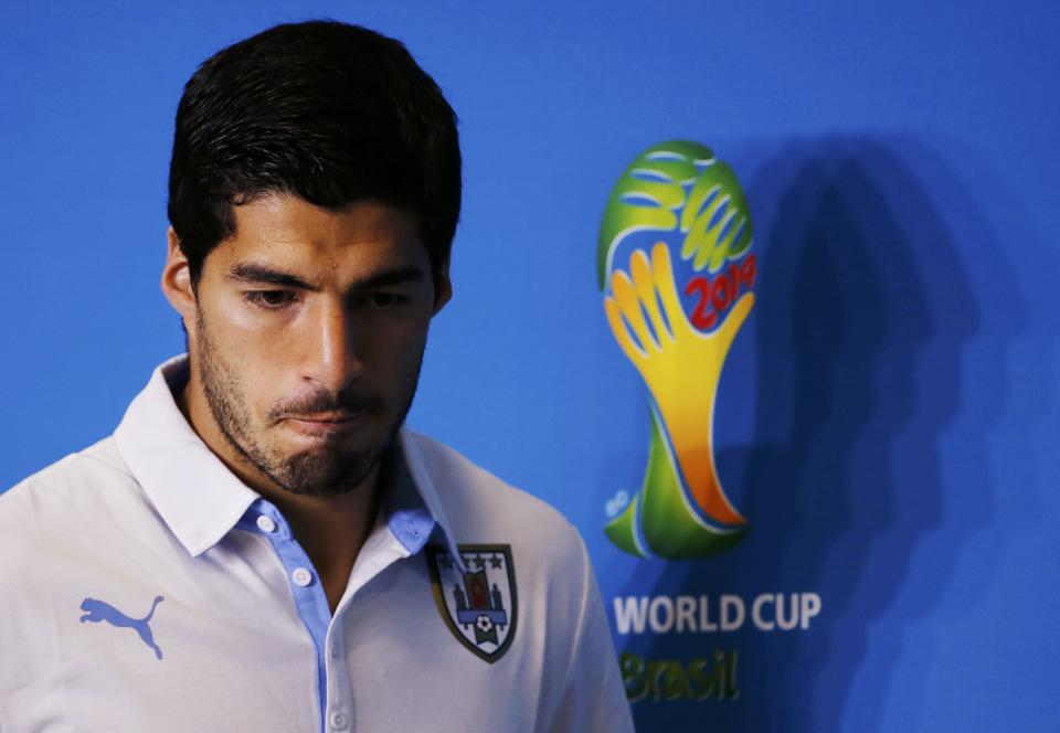 Uruguay's national soccer team player Luis Suarez attends a news conference prior to a training session at the Dunas Arena soccer stadium in Natal, in this June 23, 2014 file photograph. Suarez was banned for nine matches by FIFA on June 26, 2014 after being found guilty of biting Italian defender Giorgio Chiellini on June 24, 2014. Suarez was also banned from any football-related activity for four months and fined 100,000 Swiss francs ($111,000). REUTERS/Carlos Barria/Files (BRAZIL - Tags: SOCCER SPORT WORLD CUP)