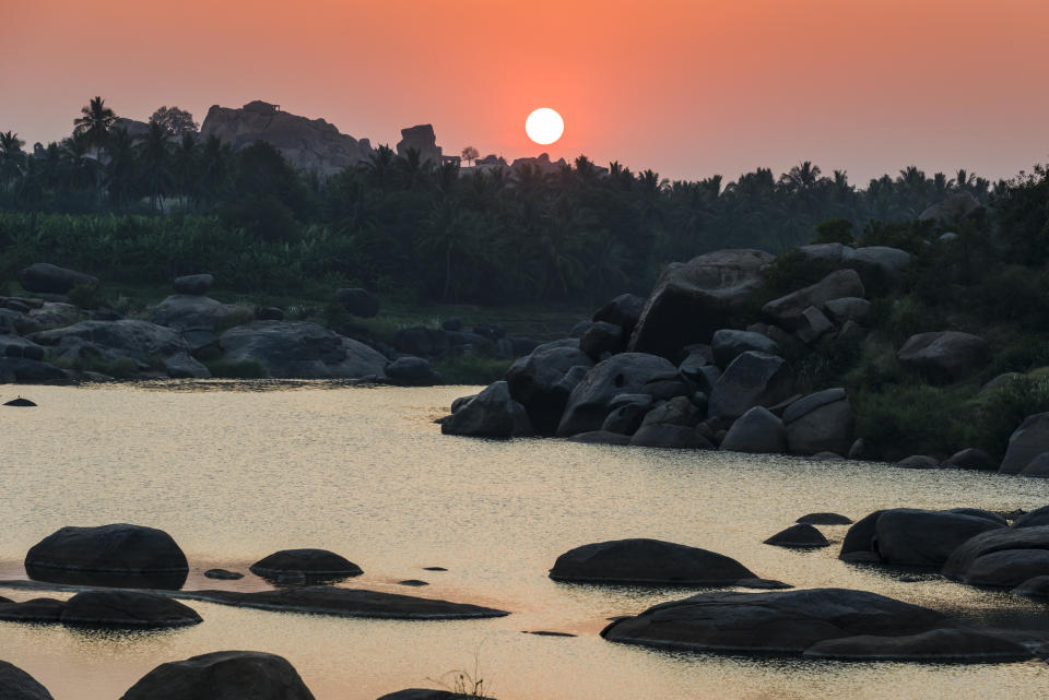 HAMPI, KARNATAKA, INDIA - 2013/12/06: Sunset over Tungabhadra river, which flows past the ruins of the former Vijayanagara Empire, which was established in 1336 by Harihara I and his brother Bukka Raya I of Sangama Dynasty and lasted until 1646. (Photo by Frank Bienewald/LightRocket via Getty Images)