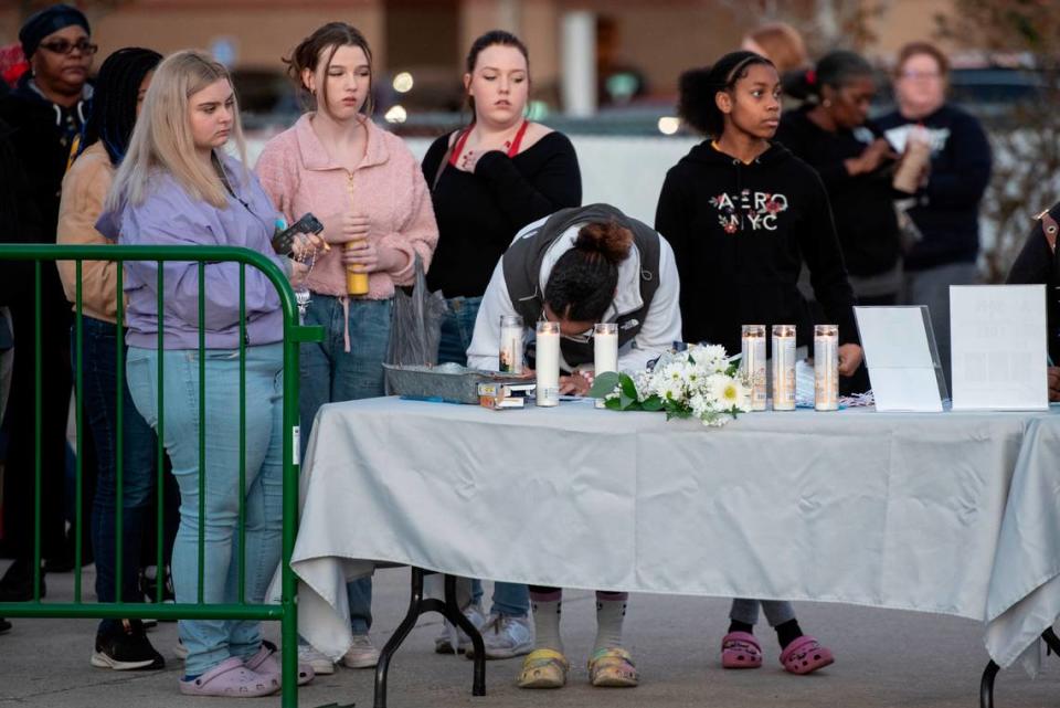 Gautier students place notes on a Christmas tree during a candlelight vigil in honor of three Gautier High School graduates, Se’Dhari Saniya Watson-Person, Kyla “Muffin” Watkins, and Tatyanna Richmond who were involved in a fatal crash, at Gautier High School in Gautier on Thursday, Dec. 7, 2023. Watson-Person and Watkins were killed in the crash.