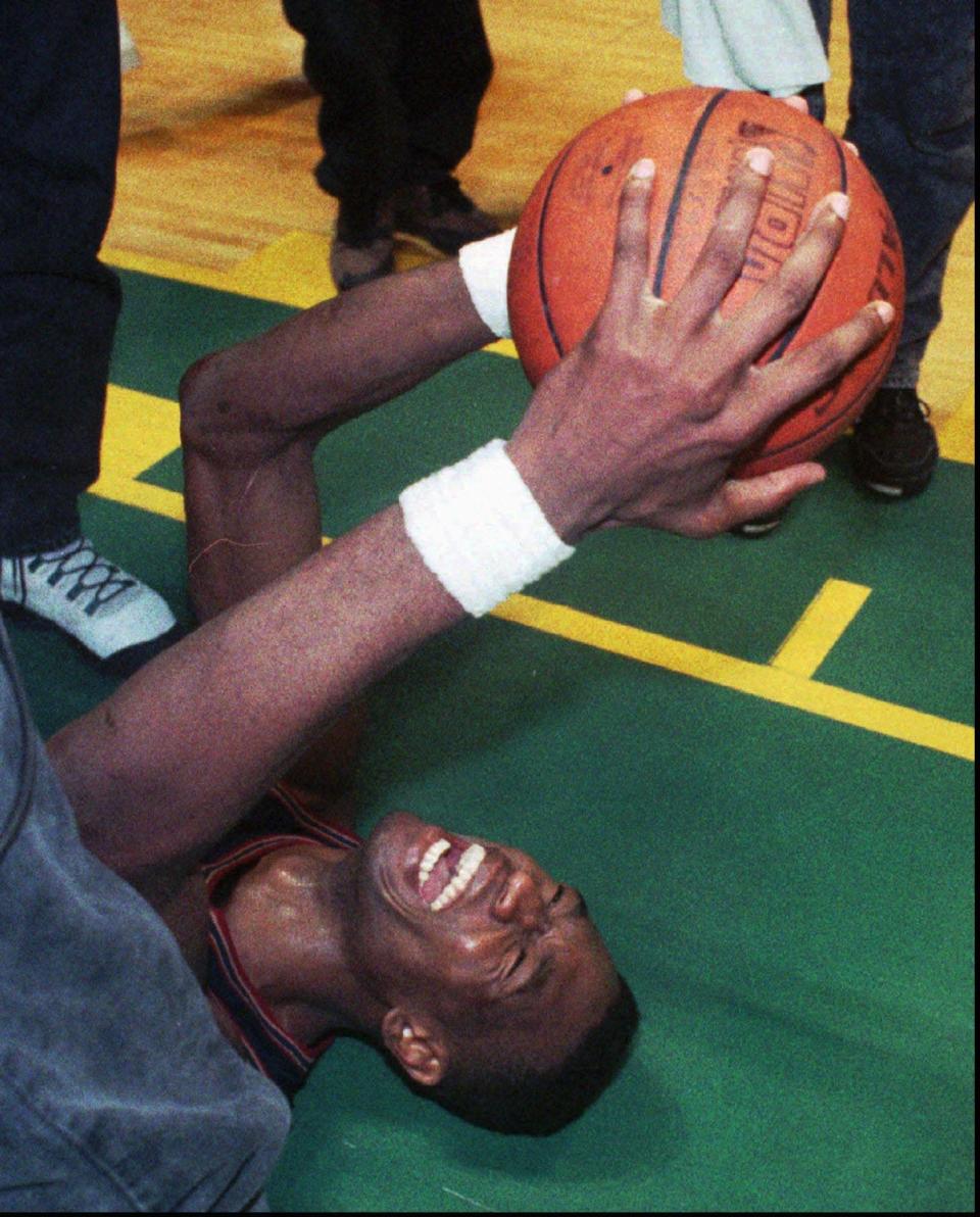 Dikembe Mutombo celebrates the Nuggets' overtime victory over the Seattle SuperSonics in the 1994 playoffs.