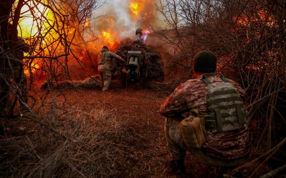 Ukrainian servicemen of the 126th Separate Territorial Defence Brigade fire a D-30 howitzer towards Russian troop