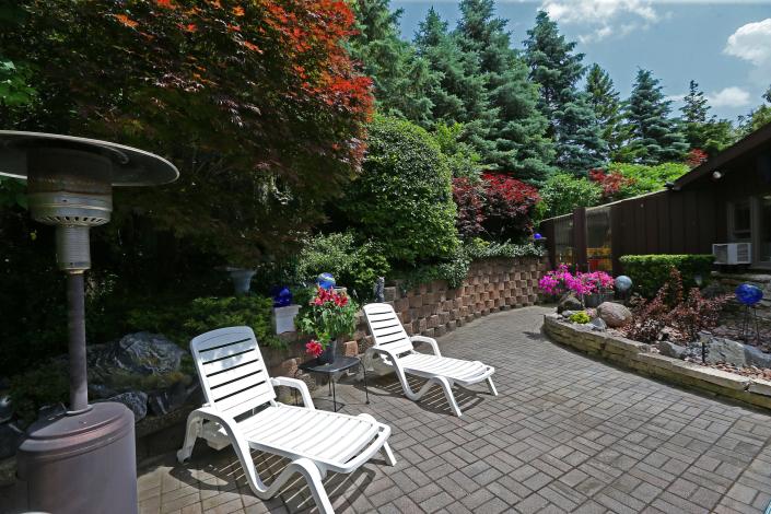 Bud Wiggins has created his own tranquil space in his backyard with berms, natural and low-maintenance landscaping.