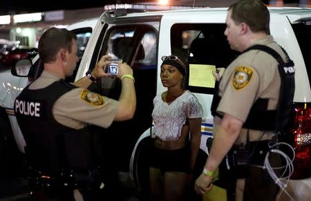 Police take a mug shot of a protester who was detained in Ferguson, Missouri, in this August 10, 2015 file photo. REUTERS/Rick Wilking/Files