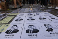 Posters of Chinese President Xi Jinping lay stuck on the ground as part of a newly created Lennon Wall in Hong Kong, Saturday, Sept. 28, 2019. Hong Kong activists first created their own Lennon Wall during the 2014 protests, covering a wall with a vibrant Post-it notes calling for democratic reform. Five years later, protestors have gathered to create impromptu Lennon Walls across Hong Kong island. (AP Photo/Vincent Thian)