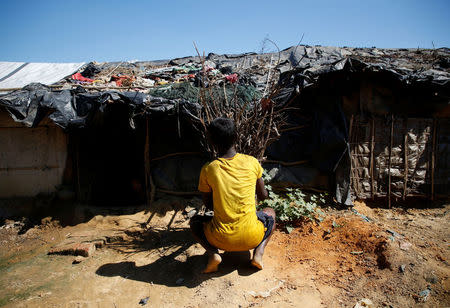 Anwar Hossain, 12, a Rohingya refugee boy, unloads fire wood outside his temporary shelter at Kutupalong refugee camp near Cox's Bazar, Bangladesh, November 12, 2017. REUTERS/Navesh Chitrakar