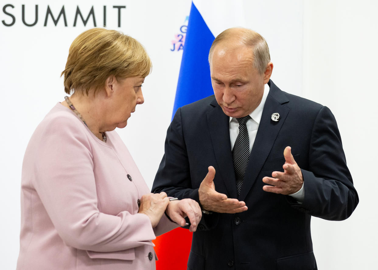 Russian President Vladimir Putin and German Chancellor Angela talk to each other during a meeting on the sidelines of the G-20 summit in Osaka, western Japan, Saturday, June 29, 2019. Alexander Zemlianichenko/Pool via REUTERS