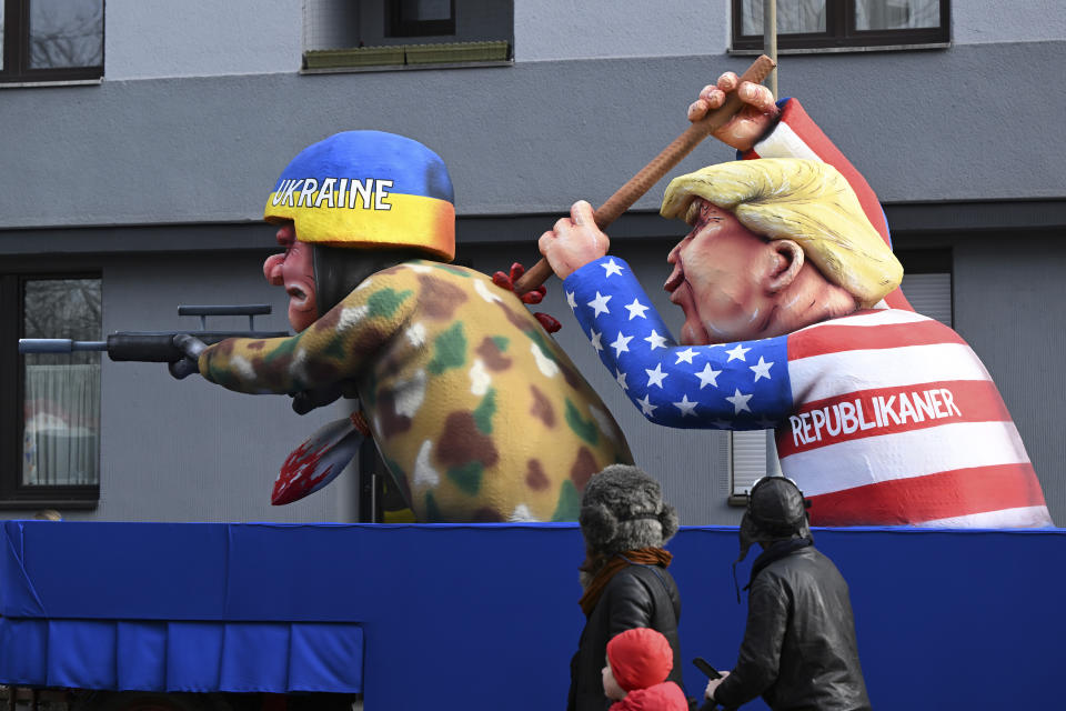 A float depicting US presidential candidate Donald Trump stabbing a Ukrainian soldier in the back is driven through the Rose Monday parade, in Düsseldorf, Germany, Monday, Feb. 12, 2024. (Federico Gambarini/dpa via AP)