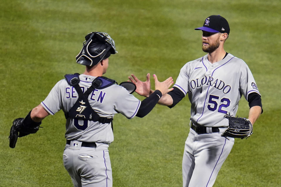 Colorado Rockies relief pitcher Daniel Bard (52) celebrates with catcher Brian Serven after the final out of the team's baseball game against the Pittsburgh Pirates in Pittsburgh, Tuesday, May 24, 2022. The Rockies won 2-1 in 10 innings. (AP Photo/Gene J. Puskar)