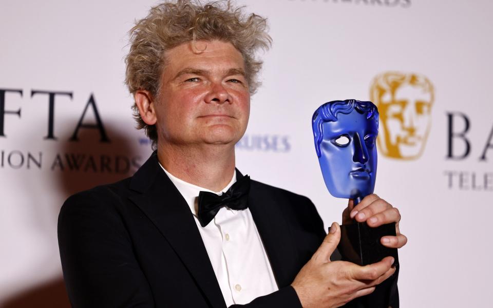 Simon Farnaby with the award for Memorable Moment, for Queen Elizabeth II and Paddington Bear - Shutterstock