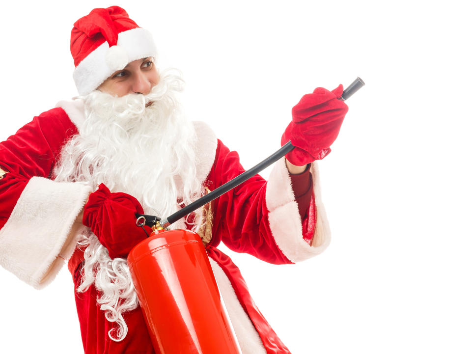 Santa holding a fire extinguisher