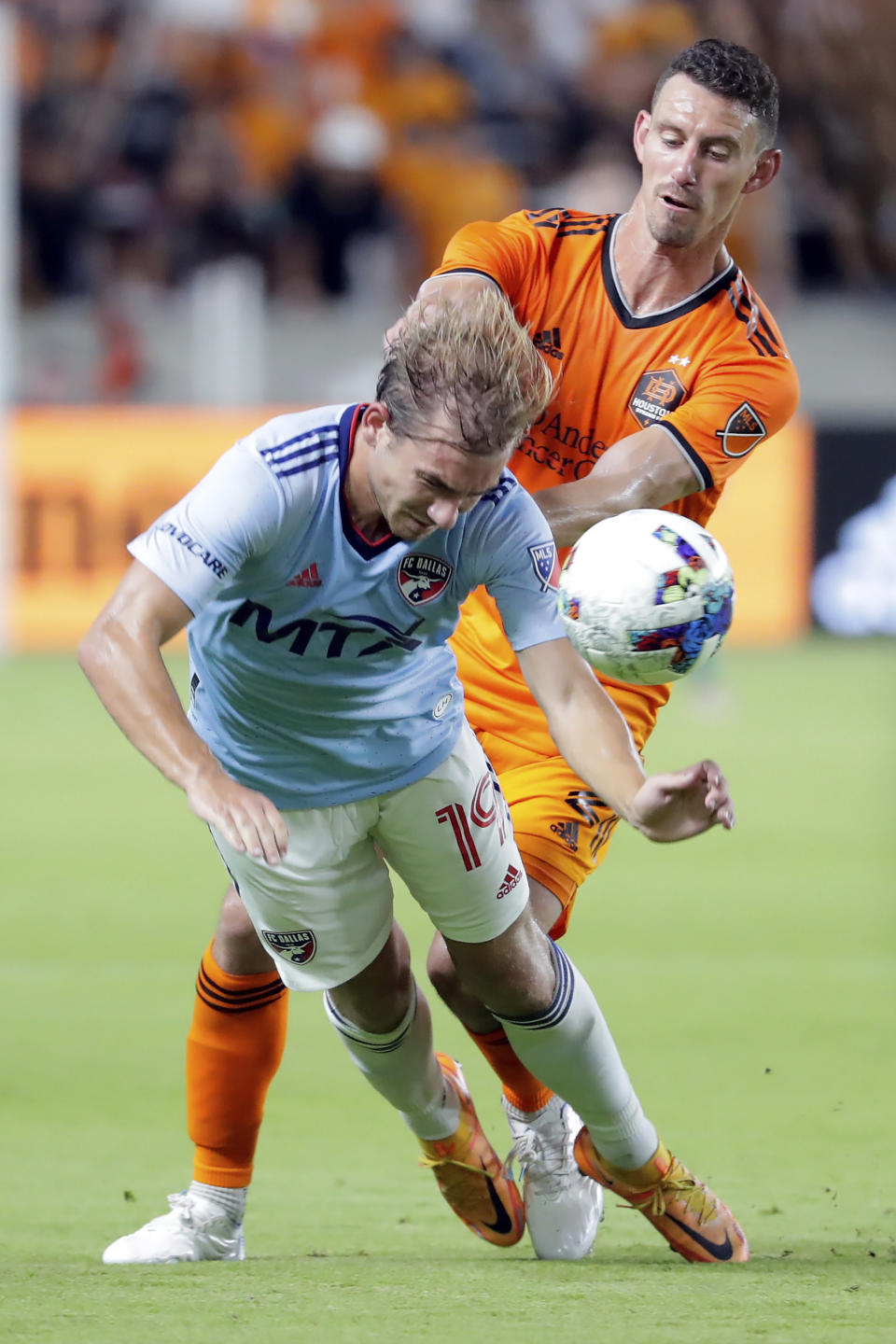 FC Dallas midfielder Paxton Pomykal (19) is pushed by Houston Dynamo defender Daniel Steres, right, during the second half of an MLS soccer match Saturday, July 9, 2022, in Houston. (AP Photo/Michael Wyke)
