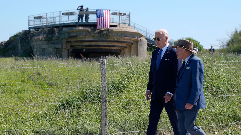 President Joe Biden walks with Scott Desjardins, superintendent of Normandy American Cemetery and Pointe du Hoc, before delivering remarks on the legacy of Pointe du Hoc, and democracy around the world on Friday, June 7, in Normandy, France. - Evan Vucci/AP