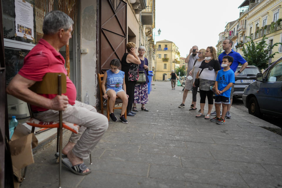 Rabbi Barbara Aiello, fourth from left, talks to a resident as she guides the Blum family for a tour of the Jewish quarter of Lamezia Terme, Thursday, July 7, 2022. From a rustic, tiny synagogue she fashioned from her family's ancestral home in this mountain village, American rabbi Aiello is keeping a promise made to her Italian-born father: to reconnect people in this southern region of Calabria to their Jewish roots, links nearly severed five centuries ago when the Inquisition forced Jews to convert to Christianity. (AP Photo/Andrew Medichini)