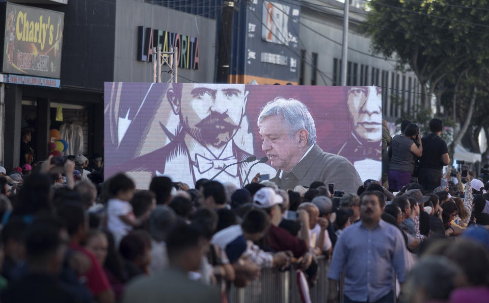 Supporters of Mexican President Andres Manuel Lopez Obrador watch his speech on a an outdoor screen during a rally in Tijuana, Mexico, Saturday, June 8, 2019. The event was originally scheduled as an act of solidarity in the face of President Donald Trump's threat to impose a 5% tariff on Mexican imports if it did not stem the flow of Central American migrants heading toward the U.S. But Mexican and U.S. officials reached an accord Friday that calls on Mexico to crackdown on migrants in exchange for Trump backing off his threat. (AP Photo/ Hans-Maximo Musielik)