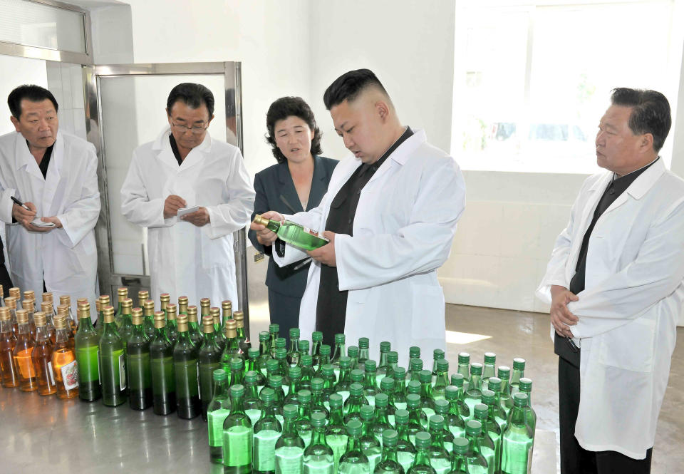 North Korea leader Kim Jong&nbsp;Un looks at bottles of alcohol as he visits the Changsong Foodstuff Factory in June of 2013.