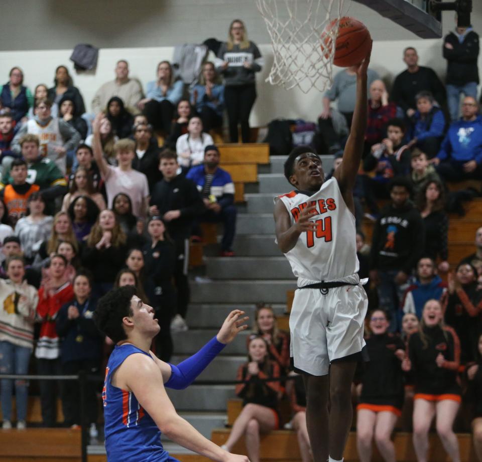 Marlboro's Chinedu Okasi	 takes a jump shot ahead of Chester's Kevin Stein during the Section 9 class B boys basketball championship in Newburgh on March 6, 2020. 