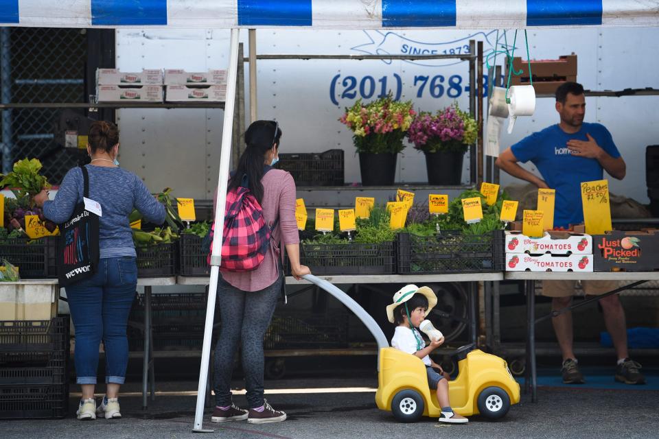 Shoppers are seen buying produce at Stokes Farm Vendor at Paramus Farmers Market on 07/07/21.