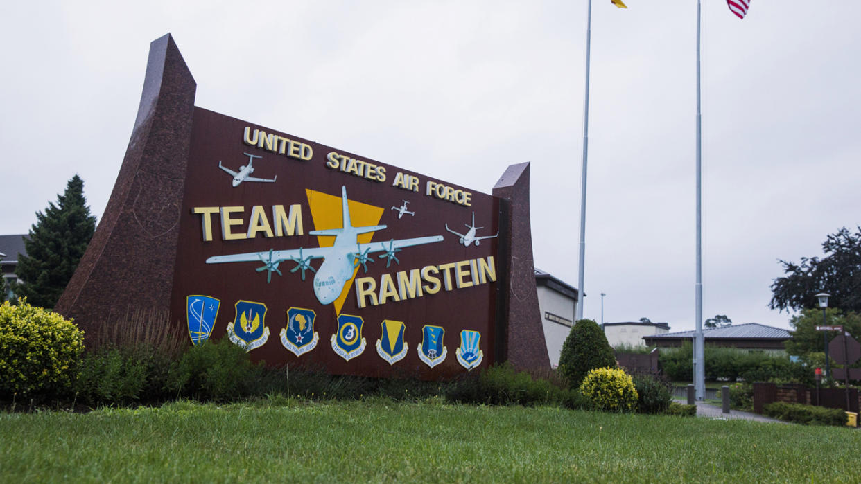 U.S. and German flags fly outside the Ramstein Air Base in Germany.