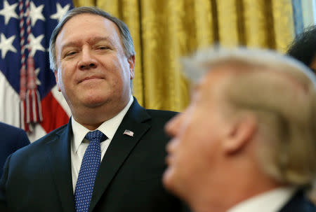 FILE PHOTO: U.S. President Donald Trump calls on his U.S. Secretary of State Mike Pompeo to speak during a presidential memorandum signing for the "Women's Global Development and Prosperity" initiative in the Oval Office at the White House in Washington, U.S., February 7, 2019. REUTERS/Leah Millis/File Photo