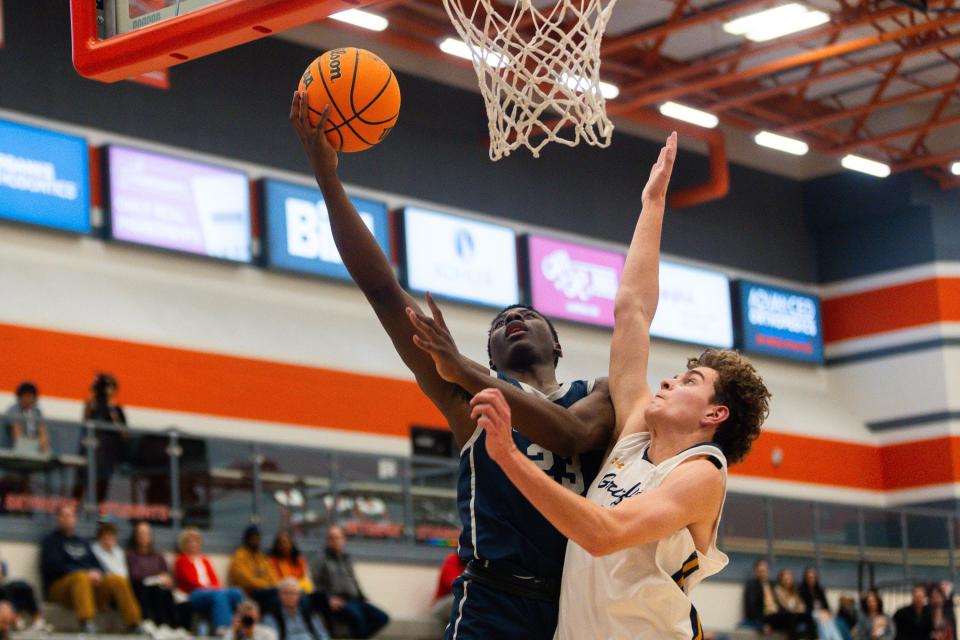 Crimson Cliffs High School’s Trevor Taylor shoots the ball with Copper Hills High School’s Tyler McVey on defense during a boys basketball semifinal game of the Allstate Falcon Classic at Skyridge High School in Lehi on Friday, Dec. 8, 2023. | Megan Nielsen, Deseret News