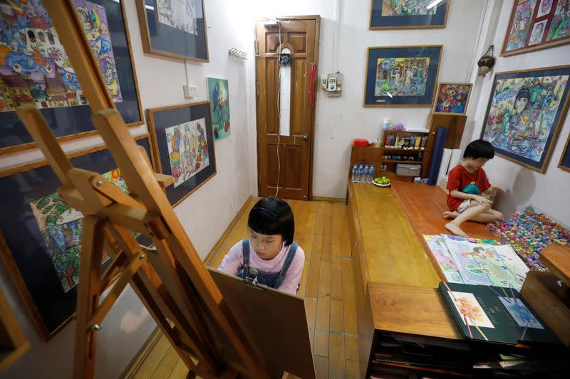 A Vietnamese school girl draws paintings about the coronavirus disease (COVID-19) in Hanoi