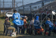 Siboniso Nene, head of the vaccination program, briefs people who came for the COVID-19 vaccination at the Swartkops railroad yard outside Gqeberha, South Africa, Wednesday Sept. 22, 2021. South Africa has sent a train carrying COVID-19 vaccines into one of its poorest provinces to get doses to areas where healthcare facilities are stretched. The vaccine train, named Transvaco, will go on a three-month tour through the Eastern Cape province and stop at seven stations for two weeks at a time to vaccinate people. (AP Photo/Jerome Delay)