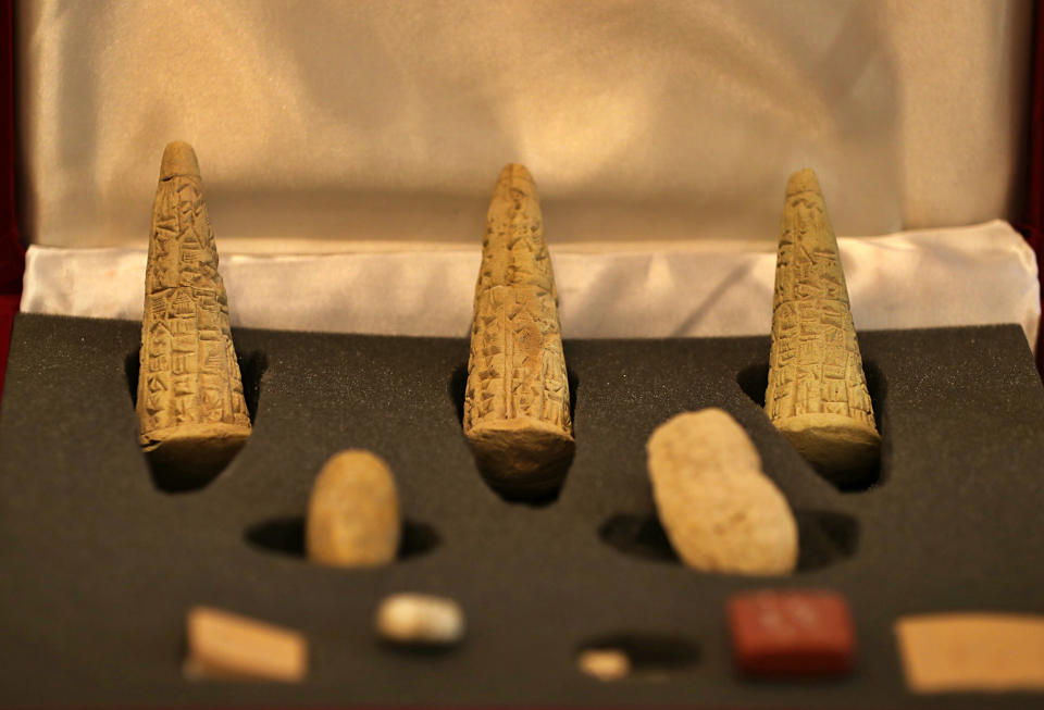 Recently recovered antiquities are displayed at the foreign ministry, in Baghdad, Iraq, Monday, July 29, 2019. The artifacts paraded Monday include archaeological and historical pieces recovered from Britain and Sweden, pottery fragments and shards with writing dating back to the ancient Sumerian civilization. Iraq is putting a great effort to restore its lost rich cultural heritage after it was decimated during the chaos that followed the 2003 U.S. invasion. (AP Photo/Hadi Mizban)