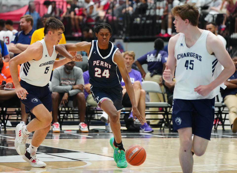 June 17, 2022; Glendale, Arizona; USA; Perry's Cody Williams (24) drives against Corner Canyon's Brody Kozlowski (15) during a game in the Section 7 basketball tournament at State Farm Stadium.