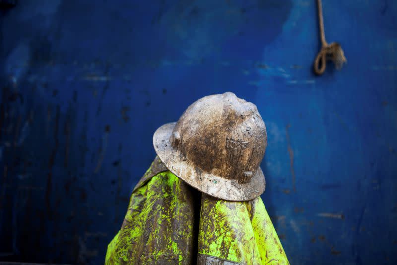 FILE PHOTO: Driller Justin Arney's hard hat and jacket rest on a truck during a lunch break, as they work to deepen the Brady family well in Woodland, California