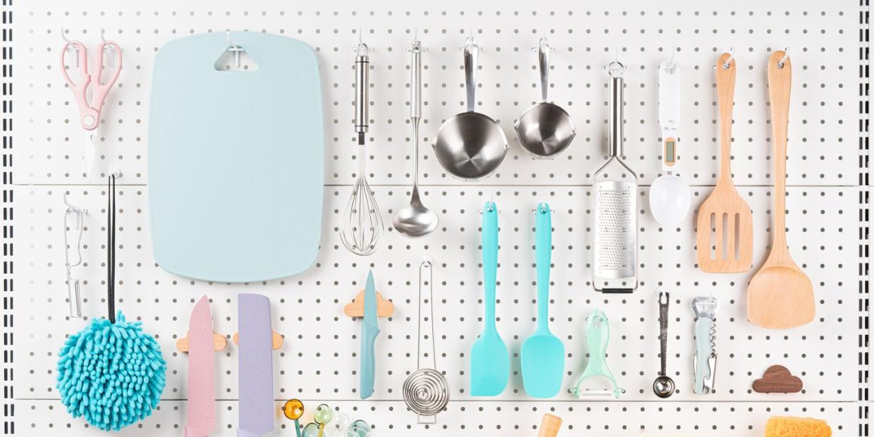 neatly organized kitchen utensils hanging on white pegboard front view pegboard organization ideas