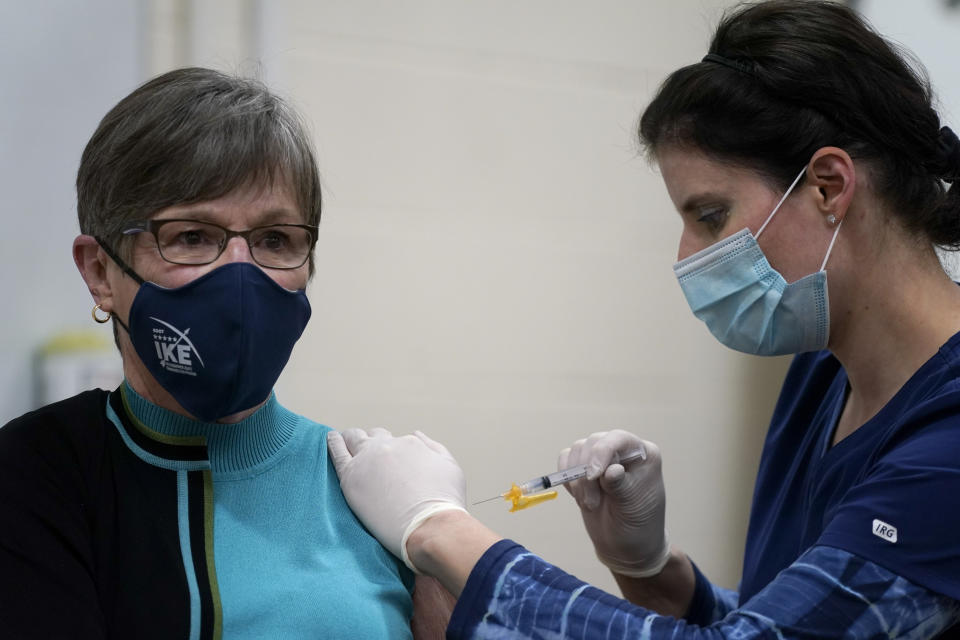 FILE - In this Wednesday, Dec. 30, 2020, file photo, Democratic Gov. Laura Kelly receives a COVID-19 vaccine injection in Topeka, Kan. In March 2021, Kelly enacted a law giving legislative leaders power to revoke her emergency orders. Top Republican lawmakers immediately used it to scuttle a Kelly order meant to encourage counties to keep mask mandates in place. (AP Photo/Charlie Riedel, File)