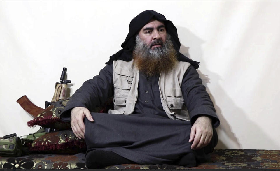 FILE - This file image made from video posted on a militant website Monday, April 29, 2019, purports to show the leader of the Islamic State group, Abu Bakr al-Baghdadi, being interviewed by his group's Al-Furqan media outlet. No longer burdened by territory and administration, Islamic State group leader Abu Bakr al-Baghdadi outlined the new path forward for his group: Widen your reach, connect with far-flung militant groups and exhaust your enemies with a “war of attrition.” (Al-Furqan media via AP, File)