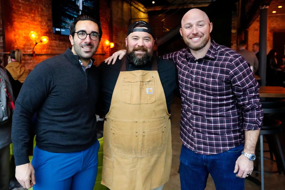 Chase Daoud (left) and Will Hodges (right) own the Well Covington. Chef Mitch Arens, who owns Grub Local, the bar's adjoining restaurant, stands in the middle.