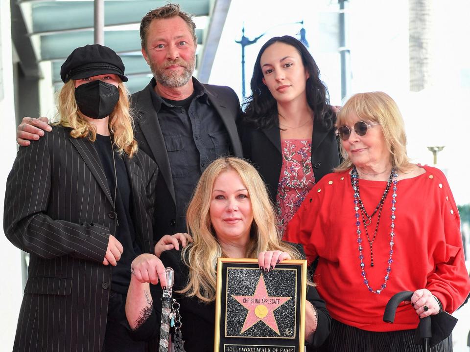 Christina Applegate, joined by (L-R) daughter Sadie Grace LeNoble, husband Martyn LeNoble, and US actress Nancy Priddy, poses for photos with Applegate's newly unveiled Hollywood Walk of Fame star in Hollywood, California, on November 14, 2022