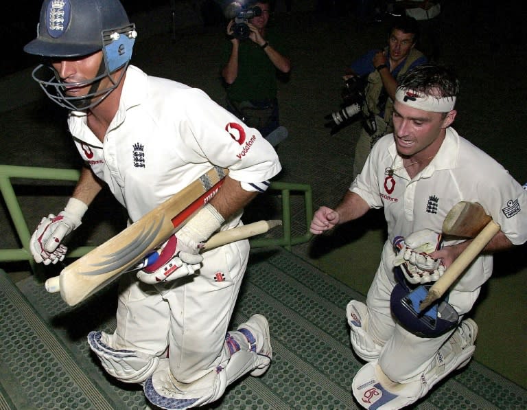 England captain Nasser Hussain (left) and Graham Thorpe rush to the English dressing room in near-darkness after their nail-biting victory in Karachi in 2000 (AAMIR QURESHI)