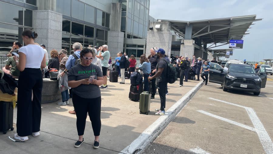 Folks line up at Austin-Bergstrom International Airport to watch the total solar eclipse on April 8, 2024. (KXAN Photo/Lauren Ryan)